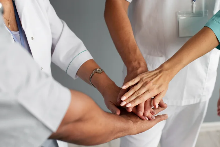 Hands joined together symbolising CARENZA's supportive, compassionate care
